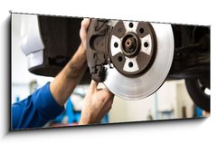 Obraz 1D panorama - 120 x 50 cm F_AB76464248 - Focused mechanic adjusting the wheel