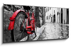 Sklenn obraz 1D panorama - 120 x 50 cm F_AB95275197 - Retro vintage red bike on cobblestone street in the old town. Color in black and white - Retro vinobran erven kolo na dldn ulici ve starm mst. Barva ern a bl