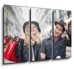 Obraz 3D tdln - 105 x 70 cm F_BB73082642 - a trendy young couple  wearing hats walking in the city in autum - mdn mlad pr nos klobouky chzi ve mst v podzimn