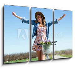 Obraz   Beautiful young woman with a vintage bike in the field., 105 x 70 cm