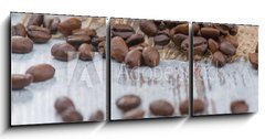 Obraz 3D třídílný - 150 x 50 cm F_BM100905478 - Coffee beans lying on the table - Kávová zrna ležící na stole