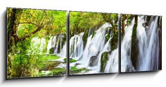 Obraz 3D třídílný - 150 x 50 cm F_BM107722539 - Scenic waterfall with crystal clear water among green forest - Scénický vodopád s křišťálově čistou vodou mezi zelenými lesy