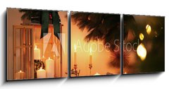 Obraz 3D třídílný - 150 x 50 cm F_BM407641595 - Wooden decorative Christmas lantern and burning candles on table indoors - Dřevěná dekorativní vánoční lampa a hořící svíčky na stole v interiéru