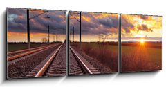 Obraz 3D třídílný - 150 x 50 cm F_BM81148616 - Orange sunset in low clouds over railroad - Oranžový západ slunce v nízkých mracích nad železnicí