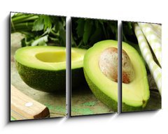 Obraz   ripe avocado cut in half on a wooden table, 90 x 50 cm