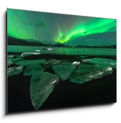 Sklenn obraz 1D - 100 x 70 cm F_E209731470 - A beautiful green and red aurora dancing over the Jokulsarlon lagoon, Iceland