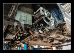 Obraz 1D - 100 x 70 cm F_E265635496 - old car on the lift at auto repair shop