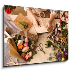 Obraz 1D - 100 x 70 cm F_E266667837 - Florist writing in notebook at table