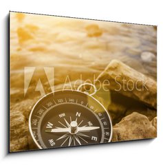 Obraz 1D - 100 x 70 cm F_E60262537 - compass on the shore at sunrise