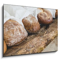 Sklenn obraz 1D - 100 x 70 cm F_E72205297 - Delicious bread on the table