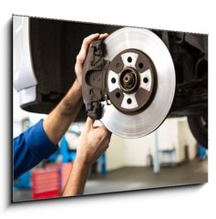 Obraz 1D - 100 x 70 cm F_E76464248 - Focused mechanic adjusting the wheel