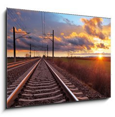 Obraz 1D - 100 x 70 cm F_E81148616 - Orange sunset in low clouds over railroad