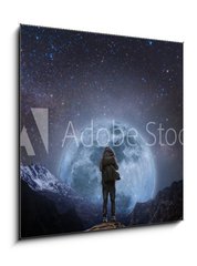 Obraz 1D - 50 x 50 cm F_F205708981 - a man with backpack standing on mountain peak at night, and silhouette mountain with bright full moon and sky full of stars