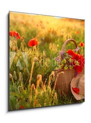 Obraz 1D - 50 x 50 cm F_F276027409 - Basket of wildflowers with straw hat in sunlit poppy field