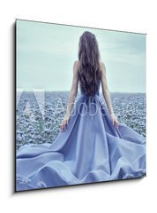 Sklenn obraz 1D - 50 x 50 cm F_F70223866 - Back view of standing young woman in blue dress - Zadn pohled na stojc mlad ena v modrch atech