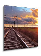 Sklenn obraz 1D - 50 x 50 cm F_F81148616 - Orange sunset in low clouds over railroad