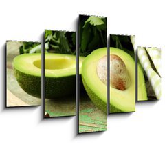 Obraz   ripe avocado cut in half on a wooden table, 150 x 100 cm