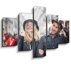Obraz   a trendy young couple wearing hats walking in the city in autum, 150 x 100 cm