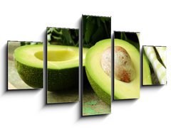 Obraz   ripe avocado cut in half on a wooden table, 125 x 70 cm