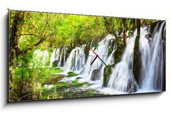 Obraz s hodinami 1D panorama - 120 x 50 cm F_AB107722539 - Scenic waterfall with crystal clear water among green forest