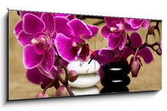Obraz s hodinami 1D panorama - 120 x 50 cm F_AB13631630 - Spa essentials (pyramid of stones with purple orchids) - Lázeňské potřeby (pyramida kamenů s fialovými orchidejemi)