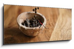 Obraz s hodinami 1D panorama - 120 x 50 cm F_AB162118409 - black dry pepper fall into wooden bowl on table