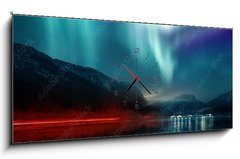 Obraz s hodinami   A large Northern Lights (aurora borealis) display glowing over a mountain pass and reflected on a lake at night. Photo composition., 120 x 50 cm