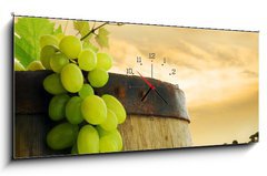 Obraz s hodinami 1D panorama - 120 x 50 cm F_AB19328212 - Wine barrel and grape with vineyard in background - Víno a vinné hrozny s vinicemi v pozadí