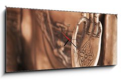 Obraz s hodinami 1D panorama - 120 x 50 cm F_AB27118507 - Die Hand des Messing-Buddhas