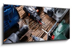 Obraz s hodinami 1D panorama - 120 x 50 cm F_AB321607758 - Power Tools On Wooden Desk