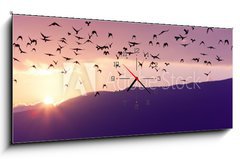 Obraz s hodinami 1D - 120 x 50 cm F_AB37700640 - Flock of Birds Flying at the Sunset above Mountian at the sunset