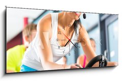 Obraz s hodinami 1D panorama - 120 x 50 cm F_AB48214367 - Leute beim Spinning in einem Fitnessstudio