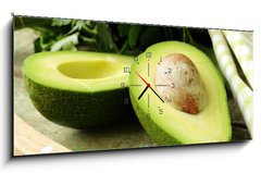 Obraz s hodinami 1D panorama - 120 x 50 cm F_AB52535934 - ripe avocado cut in half on a wooden table