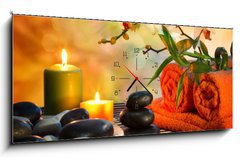 Obraz s hodinami 1D panorama - 120 x 50 cm F_AB59390339 - preparation for massage in orange lights and black stones