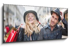 Obraz s hodinami 1D panorama - 120 x 50 cm F_AB73082642 - a trendy young couple wearing hats walking in the city in autum - módní mladý pár nosí klobouky chůzi ve městě v podzimní