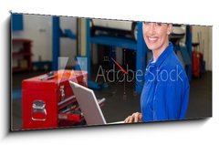 Obraz s hodinami 1D panorama - 120 x 50 cm F_AB76801978 - Mechanic typing on a laptop