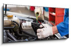 Obraz s hodinami 1D panorama - 120 x 50 cm F_AB76802503 - Mechanic pouring oil into car