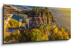 Obraz s hodinami 1D panorama - 120 x 50 cm F_AB96940052 - Pravcicka Gate in autumn colors, Bohemian Saxon Switzerland, Czech Republic - Pravčická brána v podzimních barvách, České saské Švýcarsko, Česká republika