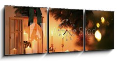 Obraz s hodinami 3D tdln - 150 x 50 cm F_BM407641595 - Wooden decorative Christmas lantern and burning candles on table indoors - Devn dekorativn vnon lampa a hoc svky na stole v interiru