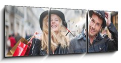 Obraz s hodinami 3D tdln - 150 x 50 cm F_BM73082642 - a trendy young couple  wearing hats walking in the city in autum