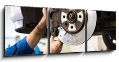 Obraz s hodinami   Focused mechanic adjusting the wheel, 150 x 50 cm