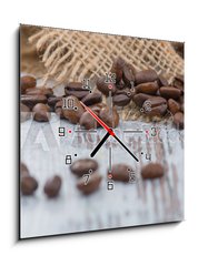 Obraz s hodinami 1D - 50 x 50 cm F_F100905478 - Coffee beans lying on the table  - Kvov zrna lec na stole