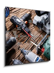 Obraz s hodinami 1D - 50 x 50 cm F_F321607758 - Power Tools On Wooden Desk