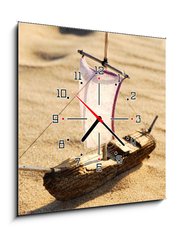 Obraz s hodinami 1D - 50 x 50 cm F_F39733382 - wooden sail ship toy model in the sea sand - dřevěná plachetnice model hračky v mořském písku