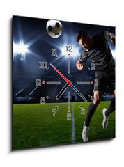 Obraz s hodinami 1D - 50 x 50 cm F_F66124797 - Hispanic Soccer Player heading the ball - Hispánský fotbalista míří míč