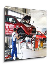 Obraz s hodinami 1D - 50 x 50 cm F_F71143570 - Reifenwechsel in einer KFZ Werkstatt // Tire change by mechanic - Reifenwechsel in einer KFZ Werkstatt // Změna pneumatik mechanikem
