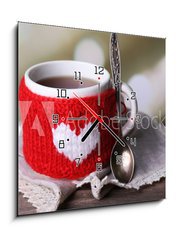 Obraz s hodinami 1D - 50 x 50 cm F_F71618914 - Cup of tasty hot tea, on wooden table, on light background - Šálek chutného horkého čaje, na dřevěném stole, na světlém pozadí