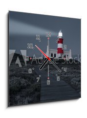 Obraz s hodinami 1D - 50 x 50 cm F_F78333041 - Lighthouse with shining light in darkness and dark blue clouds a - Maják se zářícím světlem ve tmě a tmavě modrými oblaky a