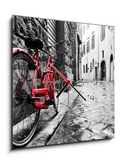 Obraz s hodinami 1D - 50 x 50 cm F_F95275197 - Retro vintage red bike on cobblestone street in the old town. Color in black and white - Retro vinobran erven kolo na dldn ulici ve starm mst. Barva ern a bl
