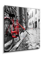 Obraz s hodinami 1D - 50 x 50 cm F_F95275197 - Retro vintage red bike on cobblestone street in the old town. Color in black and white - Retro vinobraní červené kolo na dlážděné ulici ve starém městě. Barva černá a bílá